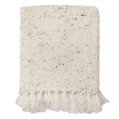 a white blanket with fringes on the bottom and brown speckles around it