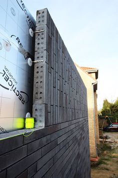 the side of a building that is being constructed with cinder blocks and steel studs