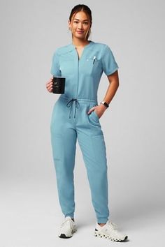 Empower Scrub Jumpsuit - Yitty Dentist Scrubs Woman, Professional Scrub Outfit, Peds Nurse Outfit, Nurse Style Scrubs Fashion, Scrubs Jumpsuit, Scrubs Uniform Aesthetic, Scrubs Uniform Cute Fashion Styles, Stylish Scrubs For Women, Esthetician Outfit Ideas