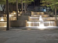 the fountains are lit up at night time