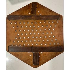 a wooden board with white dots on it