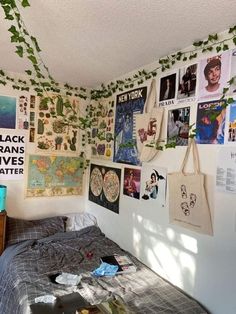 a bedroom with posters on the wall and a bed in it's center area