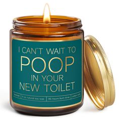 a candle that is sitting in front of a jar with the words, i can't wait to poop in your new toilet