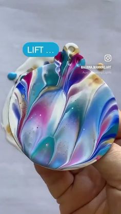 a hand holding a small glass object in it's left hand, with the text lift above it