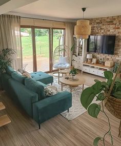 a living room filled with furniture and a flat screen tv mounted on a wall next to a wooden floor