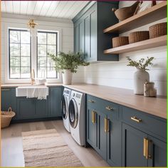 a washer and dryer in a room with blue cabinets