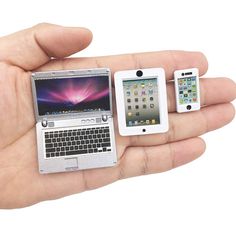 a person holding three different types of electronic devices in their hands, including an iphone and a laptop