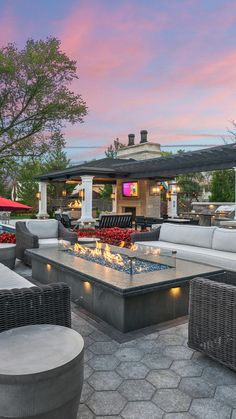 an outdoor patio with seating and fire pit