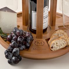 cheese, bread and grapes on a wooden platter