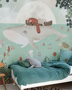 a child's bedroom with a dolphin mural on the wall