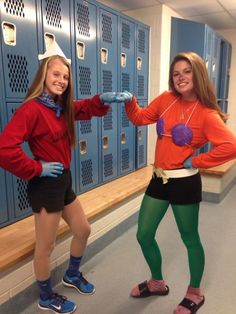 two women in costumes standing next to lockers with their hands on their hips