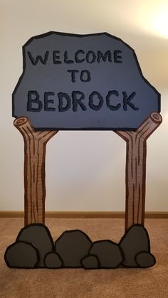 a welcome to bedrock sign on the floor