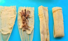 three pieces of corn on a blue cutting board