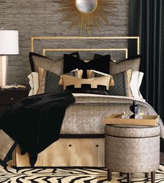 a bedroom with a large bed and black and gold decor