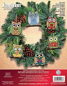 the front cover of an ornament book with owls and pine cones on it