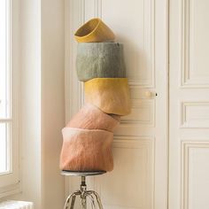 a stack of pillows sitting on top of a chair