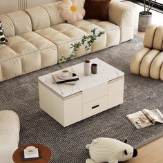 a living room filled with furniture and a coffee table on top of a carpeted floor