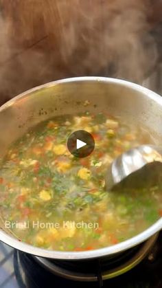 a pot filled with soup sitting on top of a stove