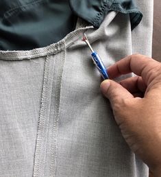 a person is holding a toothbrush in their pocket