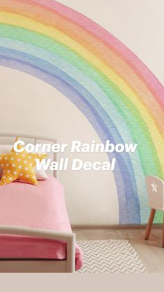 a child's bedroom with a rainbow painted on the wall