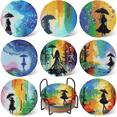 six plates with different designs on them and one has an umbrella in the rain,