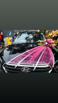 a car decorated with pink and white flowers