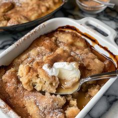 a close up of a casserole dish with ice cream and powdered sugar