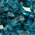 many pieces of blue glass are piled together