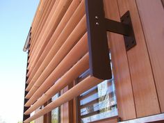 the outside of a building with wooden blinds on it