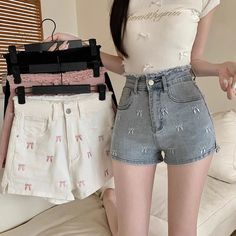 Add a touch of girly charm to your summer wardrobe with our Pretty Bow Embroidered Jean Shorts 🎀. The distressed waist and bow embroidery add a unique and cute factor to these shorts, available in four charming colors. Stay stylish and comfortable all season long. Size Chart: Size Waist (cm) Hip (cm) Length (cm) Waist (in) Hip (in) Length (in) S 60 84 30 23.62 33.07 11.81 M 64 88 31 25.20 34.65 12.20 L 68 92 32 26.77 36.22 12.60 XL 72 96 33 28.35 37.80 12.99 Description: Item Type: ShortsDecoration: Bow/Button/Embroidery/Pockets/Zipper Fabric Type: DenimPattern Type: BowsFit Type: RegularMaterial: PolyesterOrigin: CNWaist Type: HighClosure Type: Zipper Fly Feminine Cotton Shorts, Cute High Waist White Shorts, Cute High-waisted Shorts For Spring, Cute Short-length Bottoms For Spring, Cute Short Length Bottoms For Spring, Trendy Spring Bottoms With Bow Detail, Cute Cotton High-waisted Shorts, Cute High-waisted Cotton Shorts, Chic Summer Bottoms With Bow Detail