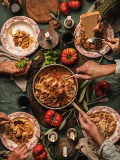 several people are eating food at a table with plates and spoons on the table