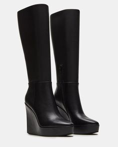 The AKIRA knee-high boot features a platform wedge design and a convenient inside zipper for easy on and off. Elevate your style game with this versatile and stylish boot, perfect for any occasion. 4.5 inch heel height Size 6 measurements: 14 inch shaft circumference, 13.75 inch shaft height Size 8 measurements: 15 inch shaft circumference, 14.75 inch shaft height Size 10 measurements: 16 inch shaft circumference, 15.75 inch shaft height Leather upper material Textile lining Synthetic sock Synth Winter Wedges, Knee High Wedge Boots, Black Wedge Boots, Knee High Platform Boots, Platform Boots Women, Summer Wardrobe Staples, Wardrobe Capsule, High Leather Boots, Black Wedge