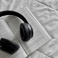 an open book with headphones on top of it