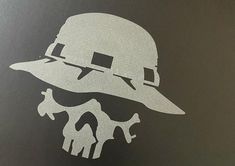 a white skull wearing a hat on top of a black surface