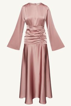 Indulge in luxury and sophistication with our Shams Satin Side Rouched Maxi Dress in Dusty Rose. The elegant hue is enhanced by the side rouched detailing, creating a flattering silhouette. The dramatic flare sleeves add a touch of drama and femininity to this must-have piece. Model is 5'7" and is wearing size XS/58". Dress Rose Gold Hijab, Bridesmaid Satin Hijab, Model Dress Satin, Modest Bridesmaid Dress, Satin Dress Design, Satin Dress Hijab, Dress Bridesmaid Satin, Modest Fashion Aesthetic, Dusty Rose Gown