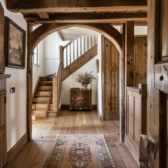 An English countryside hallway showcasing traditional architectural elements, such as a stunning wooden staircase, arched doorways, and exposed wooden beams4 Rustic House Outside, English Cottage Staircase, Houses With Personality, English Country House Aesthetic, Houses With Character Interior, Rustic English Cottage Interiors, English Houses Interior, Old English Country House Interior, English Style Home Interior Design