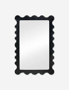 a square mirror with scalloped edges in black