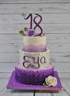 a purple and white cake with flowers on top