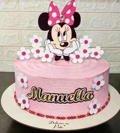 a minnie mouse cake with flowers on top