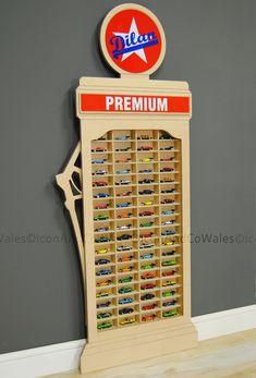 a wooden display case with toy cars on it and a sign that says delux