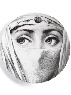 a black and white drawing of a woman's face with her head covered by a veil