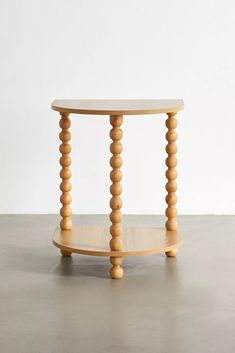 a round wooden table with three legs