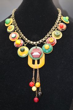 a necklace on a mannequin with lots of beads and charms hanging from it