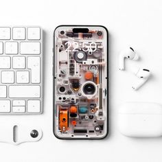 an iphone is shown next to a keyboard and earbuds