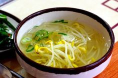 a bowl filled with noodles and vegetables on top of a table