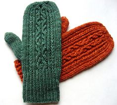 two knitted mittens sitting next to each other on top of a white surface