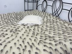 the bed is made with white and black feathers