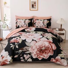 a black and pink bed with flowers on it