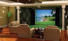 a living room filled with furniture and a flat screen tv sitting on top of a wall