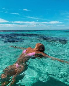 a woman swimming in the ocean with clear water